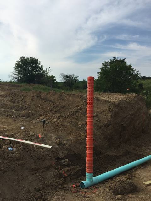 Perforated standpipe riser connected to drain tile