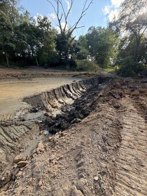 Pond excavation showing cut soil layers