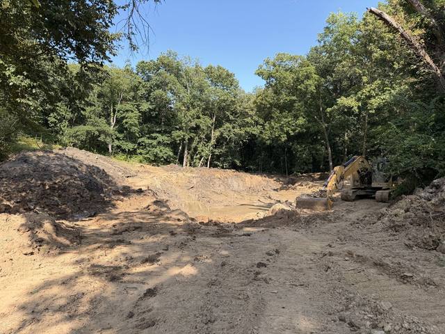 Excavator and dozer working a pond site