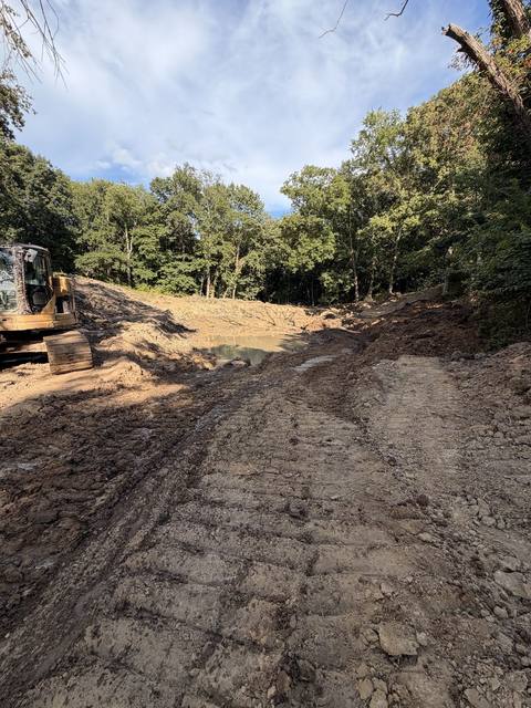Pond basin taking shape with equipment nearby