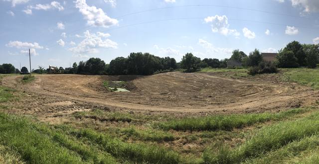 Wide panorama of a graded pond basin